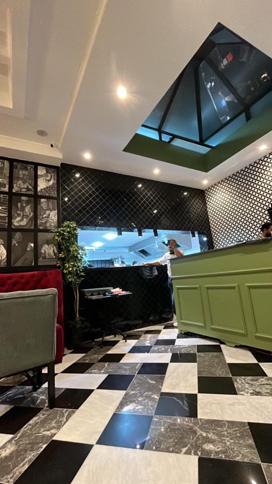 Open kitchen and green bar under the glass skylight